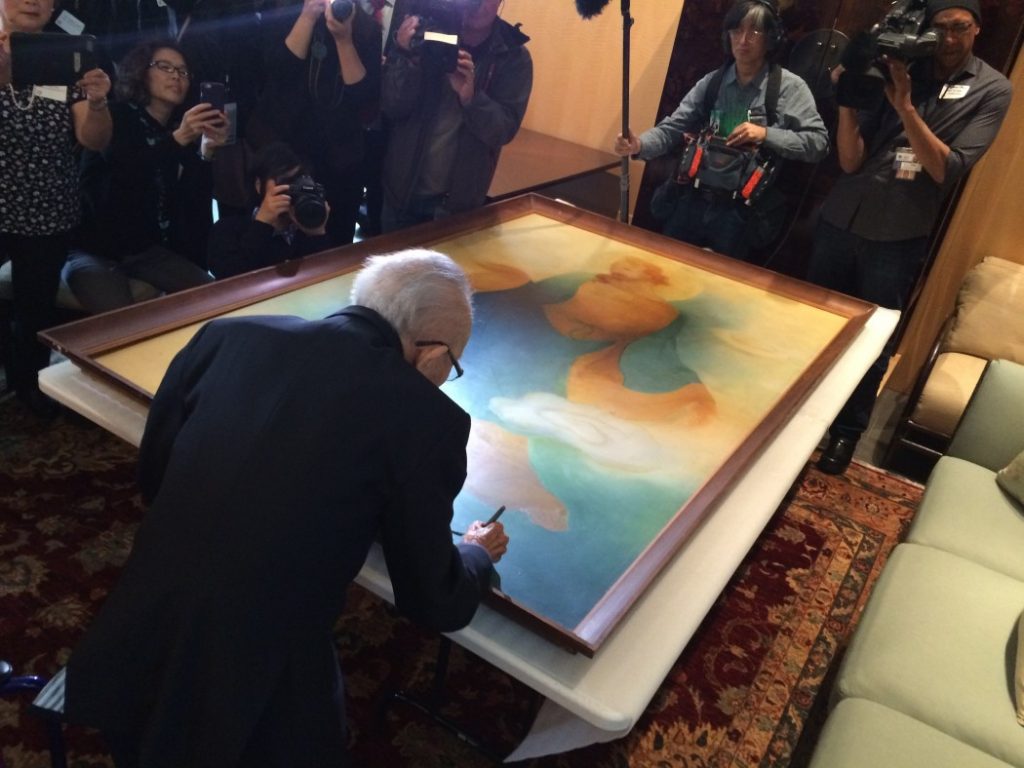 Tyrus Wong signs a painting from the 1930s at the Asian Art Museum on March 9, 2016. Photo by Ravi Chandra.